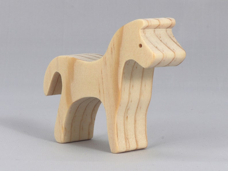 Handmade wooden toy horse cutout, perfect for children's playtime collection. Freestanding and stackable, ready to paint or customize. Endless possibilities for imaginative play, from farm scenes to towering animal creations.