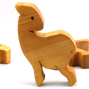 Handmade wooden toy stacking puzzle with five freestanding goats finished with a custom blend of nontoxic oils and waxes.