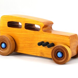 Handcrafted wooden hot rod toy car modeled after a classic '32 sedan. Finished with amber shellac and adorned with metallic sapphire blue and black trim. This unique piece is part of my Hot Rod Collection.