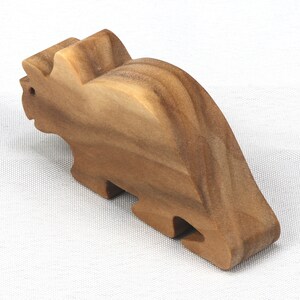 This small wooden triceratops dinosaur toy is crafted from high-quality hardwood and hand-finished. It is a delightful plaything for young children and appeals to many adults.