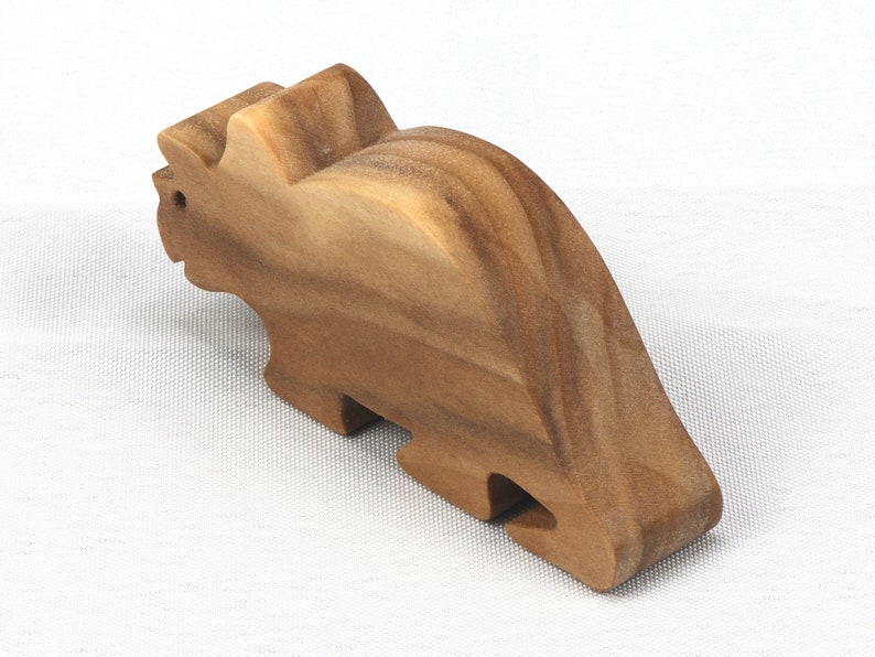 This small wooden triceratops dinosaur toy is crafted from high-quality hardwood and hand-finished. It is a delightful plaything for young children and appeals to many adults.