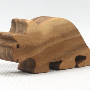 This small wooden triceratops dinosaur toy is crafted from high-quality hardwood and hand-finished. It is a delightful plaything for young children and appeals to many adults.