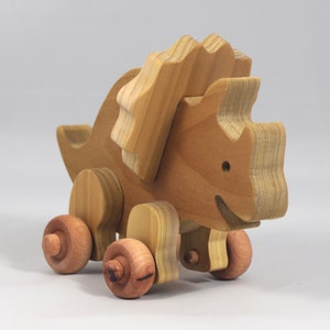 Handmade wooden push toy Triceratops dinosaur made from select grade hardwoods and finished with a non-toxic coating.