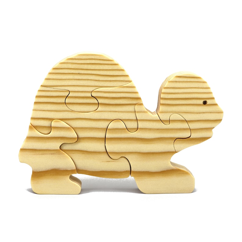 Handmade wooden turtle puzzle with 5 simple interlocking pieces. Freestanding 5-piece wooden puzzle. Approximate dimensions: 5 inches high by 7.25 inches long by 0.75 inches thick. Finished with mineral oil and beeswax blend. Handcrafted in Tallahassee, Florida, USA, using natural wood. Unique wood grain color and knot variations. Odin’s Toy Factory.