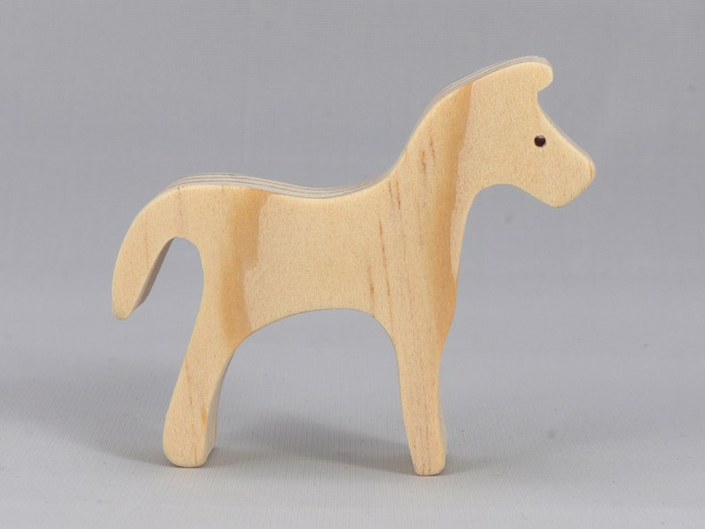 Handmade wooden toy horse cutout, perfect for children's playtime collection. Freestanding and stackable, ready to paint or customize. Endless possibilities for imaginative play, from farm scenes to towering animal creations.