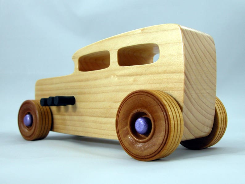 Handmade wooden toy car Hot Rod '32 Sedan finished with polyurethane, metallic purple and black trim, and nonmarring amber shellac wheels.