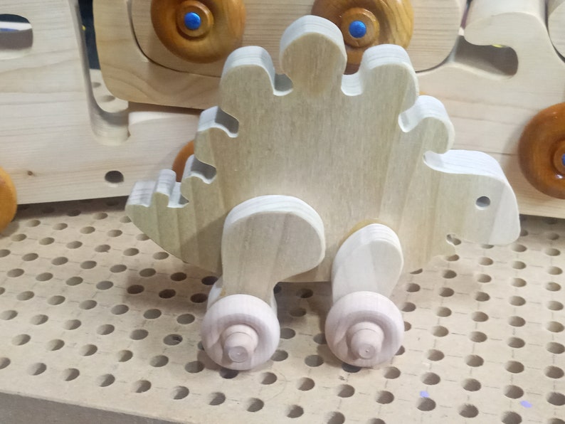 Handmade push toy stegosaurus crafted from select grade hardwoods in my toymakers shop.