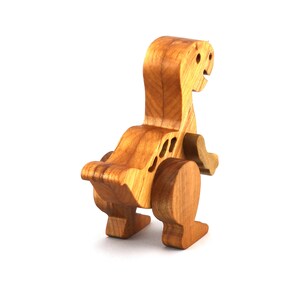 A wooden baby dinosaur figurine handmade and finished from select-grade hardwoods. It is an excellent toy for kids of any age. It is one of several dinosaurs in my collection.
