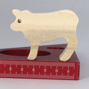 Handmade unfinished wooden toy baby calf cutout, unpainted and ready to paint, freestanding farm animal figure from Odin's Toy Factory’s  Itty Bitty Animal Collection. Handcrafted in Tallahassee, Florida, USA, using reclaimed natural wood offcuts. Perfect for imaginative play, stacking, collectors, and crafting.