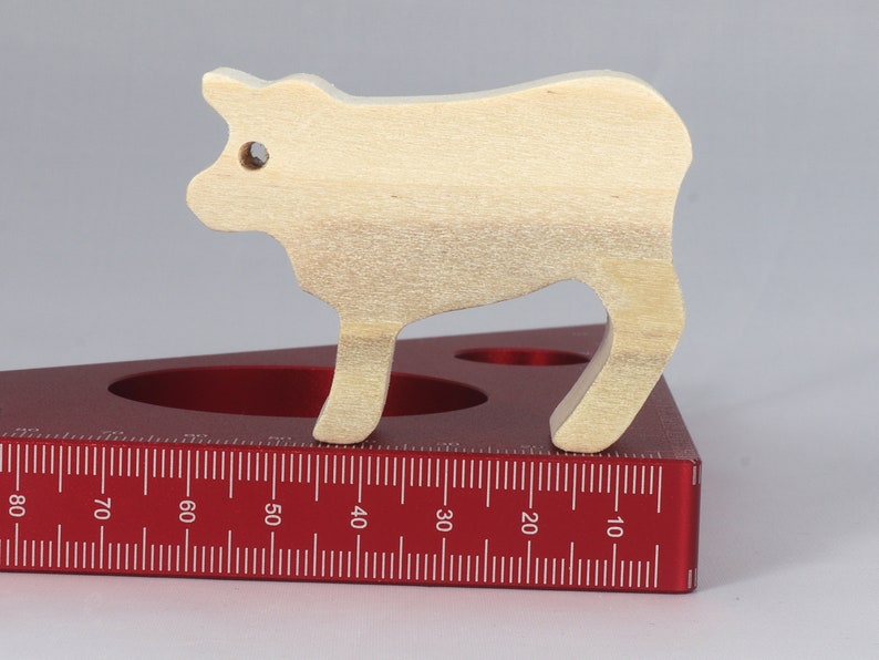 Handmade unfinished wooden toy baby calf cutout, unpainted and ready to paint, freestanding farm animal figure from Odin's Toy Factory’s  Itty Bitty Animal Collection. Handcrafted in Tallahassee, Florida, USA, using reclaimed natural wood offcuts. Perfect for imaginative play, stacking, collectors, and crafting.