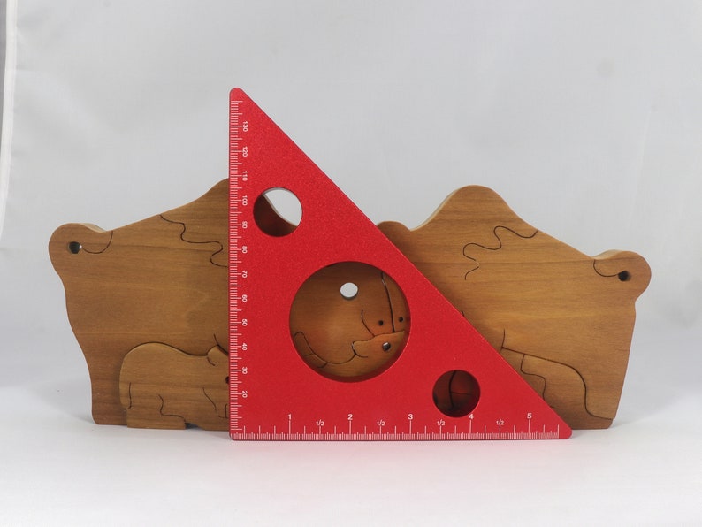 Wooden 6-piece bison family puzzle with two adult bison and four calves. The hardwood pieces interlock into one standing group or separate to stand alone. Handnmade in Tallahassee, Florida, USA by Odin's Toy Factory.
