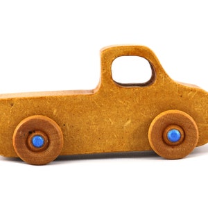 This handmade toy pickup truck from My Play Pal Collection is finished with amber shellac and metallic sapphire blue acrylic paint. It is just one of many unique wooden vehicles available.