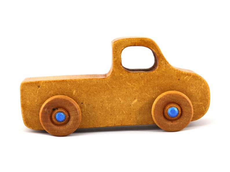 This handmade toy pickup truck from My Play Pal Collection is finished with amber shellac and metallic sapphire blue acrylic paint. It is just one of many unique wooden vehicles available.