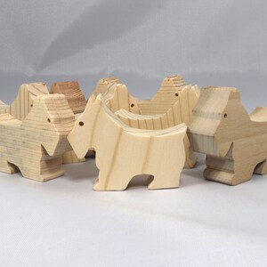 Handmade wood toy Scottie dog cutout unfinished unpainted paintable freestanding Itty Bitty Animal Collection. Approximate size 2.5 inches length by 2 inches height by 0.75 inches width. Handmade in Tallahassee Florida USA from natural wood offcuts.