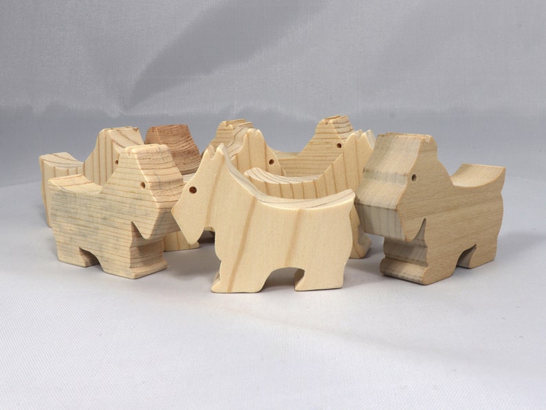 Handmade wood toy Scottie dog cutout unfinished unpainted paintable freestanding Itty Bitty Animal Collection. Approximate size 2.5 inches length by 2 inches height by 0.75 inches width. Handmade in Tallahassee Florida USA from natural wood offcuts.
