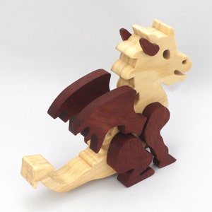 Hand-crafted baby dragon mythical fantasy animal figurine made from contrasting high-quality hardwoods and finished with non-toxic oils and waxes. Perfect for any dragon enthusiast.