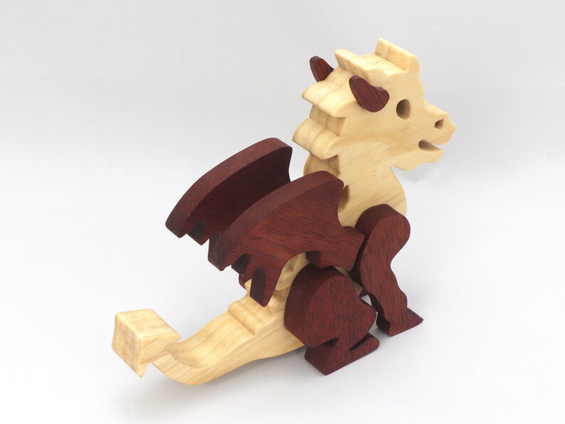 Hand-crafted baby dragon mythical fantasy animal figurine made from contrasting high-quality hardwoods and finished with non-toxic oils and waxes. Perfect for any dragon enthusiast.