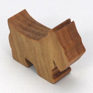 Handmade wooden Scottie dog toy cutout finished with mineral oil and beeswax blend. Freestanding stackable design from my Itty Bitty Animal Collection. Handcrafted in Tallahassee, Florida, USA from quality hardwood. Approximate size: length 2-1/2 inches, height 2 inches, width 3/4 inch. Each piece is unique with natural wood grain variations.