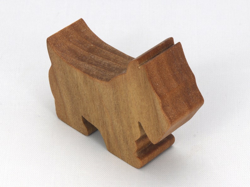 Handmade wooden Scottie dog toy cutout finished with mineral oil and beeswax blend. Freestanding stackable design from my Itty Bitty Animal Collection. Handcrafted in Tallahassee, Florida, USA from quality hardwood. Approximate size: length 2-1/2 inches, height 2 inches, width 3/4 inch. Each piece is unique with natural wood grain variations.