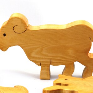 Handmade wooden toy stacking puzzle with five freestanding goats finished with a custom blend of nontoxic oils and waxes.