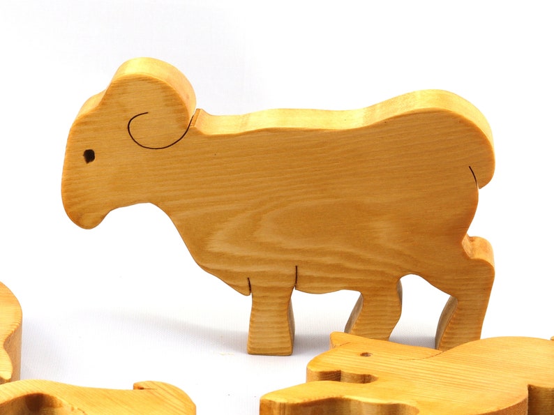 Handmade wooden toy stacking puzzle with five freestanding goats finished with a custom blend of nontoxic oils and waxes.