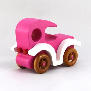 Handmade wooden toy car model-t sedan finished with hot pink and white acrylic paint with nonmaring amber shellac coated spoked wheels from my Bad Bob'S Custom Motors Collection.