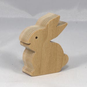 This is an unfinished wooden Rabbit cutout from solid wood using traditional woodworking techniques. Sanded smooth and ready to paint, stain, or customize. Freestanding design for small hands, toddlers, young children, crafters, collectors, and display. I take custom orders for any animal, quantity, and mix — including large ornament orders. Mix and match, request a different size, or send a drawing or pattern. Handmade by Odin's Toy Factory in Tallahassee, Florida, USA.
