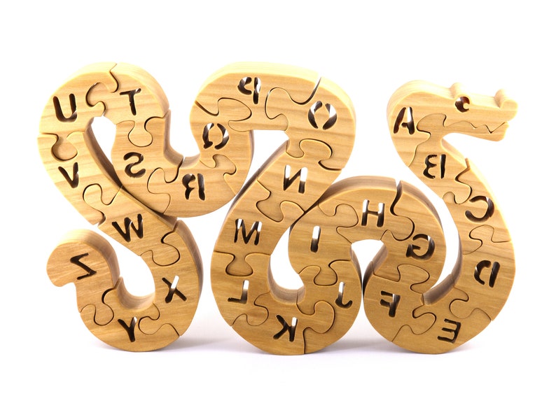 Hand-cut Alphabet Snake Puzzle made from premium hardwood, finished with mineral oil and beeswax for durability. Each of the 26 pieces represents a letter, promoting alphabet learning and essential skills development in kids through play.