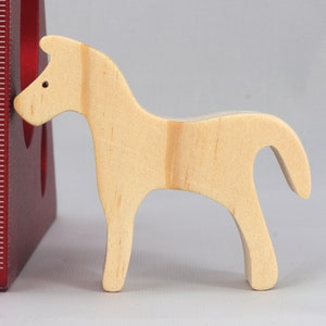 Handmade wooden toy horse cutout, perfect for children's playtime collection. Freestanding and stackable, ready to paint or customize. Endless possibilities for imaginative play, from farm scenes to towering animal creations.