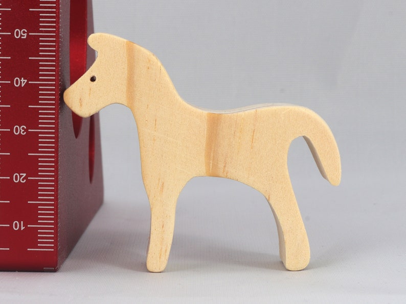 Handmade wooden toy horse cutout, perfect for children's playtime collection. Freestanding and stackable, ready to paint or customize. Endless possibilities for imaginative play, from farm scenes to towering animal creations.