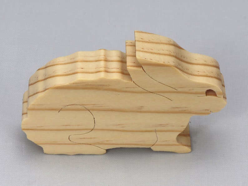This is an unfinished wooden Rabbit cutout from solid wood using traditional woodworking techniques. Sanded smooth and ready to paint, stain, or customize. Freestanding design for small hands, toddlers, young children, crafters, collectors, and display. I take custom orders for any animal, quantity, and mix — including large ornament orders. Mix and match, request a different size, or send a drawing or pattern. Handmade by Odin's Toy Factory in Tallahassee, Florida, USA.