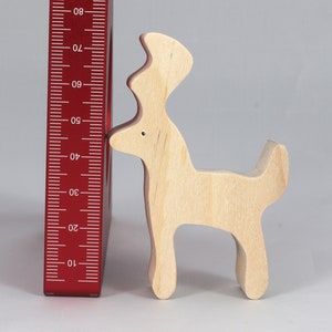 Handmade unfinished wooden deer toy figurine, part of the Itty Bitty Animal Collection, shown in natural light wood with visible grain, standing on a white background.