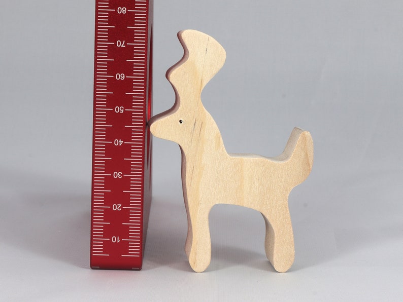Handmade unfinished wooden deer toy figurine, part of the Itty Bitty Animal Collection, shown in natural light wood with visible grain, standing on a white background.