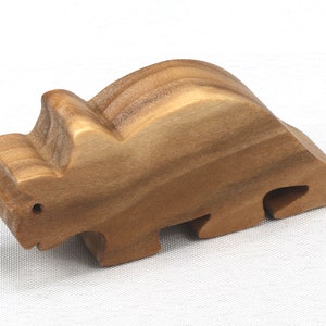 This small wooden triceratops dinosaur toy is crafted from high-quality hardwood and hand-finished. It is a delightful plaything for young children and appeals to many adults.