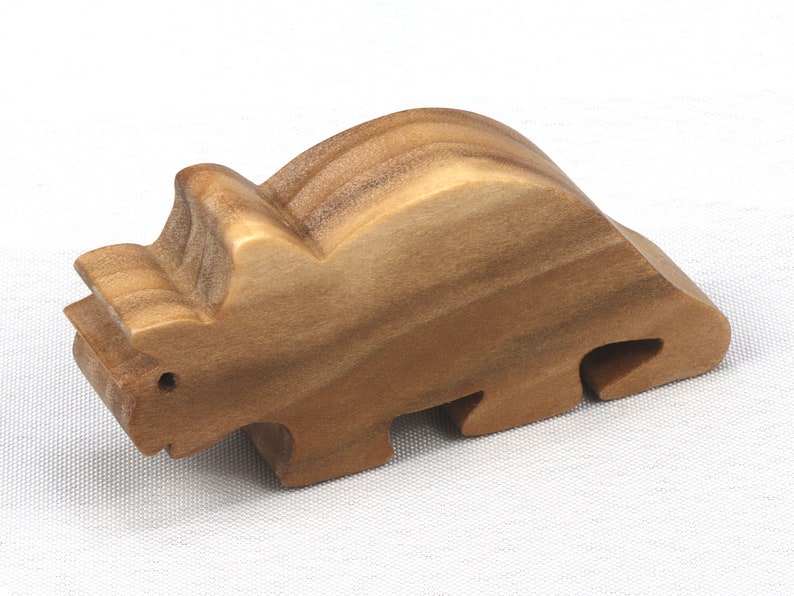 This small wooden triceratops dinosaur toy is crafted from high-quality hardwood and hand-finished. It is a delightful plaything for young children and appeals to many adults.