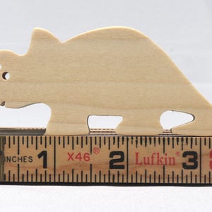 This is an unfinished wooden Wooden Toy Dinosaur Triceratops cutout from solid wood using traditional woodworking techniques. Sanded smooth and ready to paint, stain, or customize. Freestanding design for small hands, toddlers, young children, crafters, collectors, and display. I take custom orders for any animal, quantity, and mix — including large ornament orders. Mix and match, request a different size, or send a drawing or pattern. Handmade by Odin's Toy Factory in Tallahassee, Florida, USA.