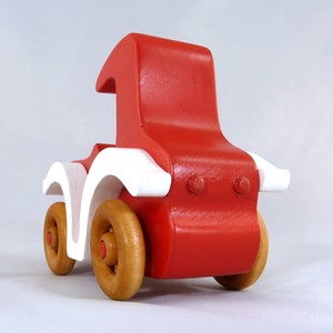 Handmade wooden toy car, vintage style red Model T Coupe by Odin's Toy Factory. Two-tone red and white acrylic paint with spoked wooden wheels finished in amber shellac. Approximate dimensions: 5 inches long, 4 inches high, 2.5 inches wide. Part of Bad Bob’s Custom Motors Collection. Crafted from natural wood using traditional woodworking tools. Handmade in Tallahassee, Florida, USA.
