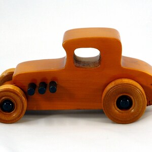 Handmade Wood Toy Car Hot Rod Based On The 1927 T-Coupe. It Has Been Hand-Finished With Multiple Coats Of Amber Shellac And Trimmed With Black Acrylic Paint.
