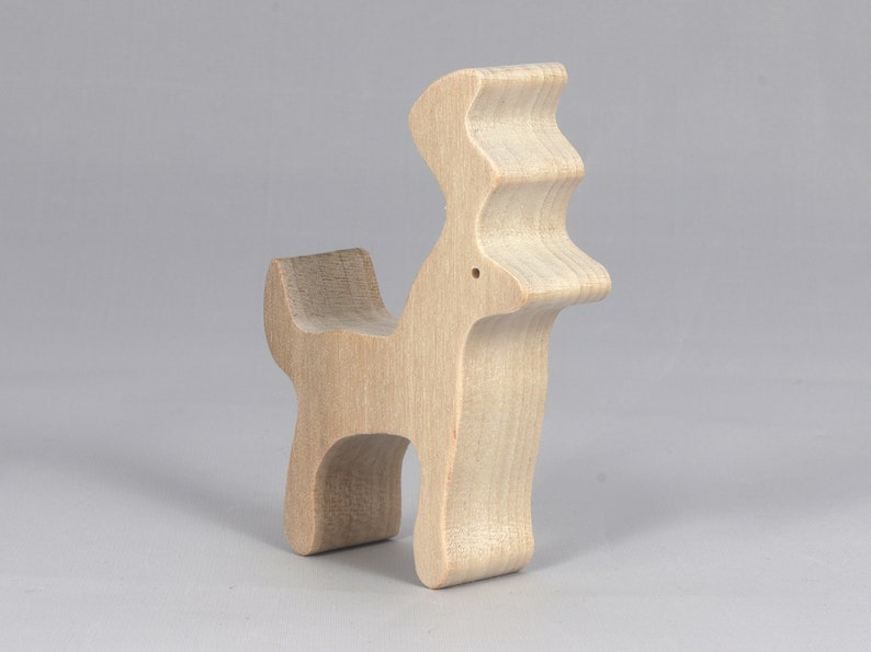 Handmade unfinished wooden deer toy figurine, part of the Itty Bitty Animal Collection, shown in natural light wood with visible grain, standing on a white background.
