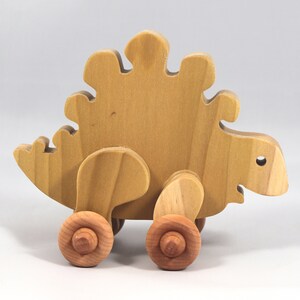 Handmade push toy stegosaurus crafted from select grade hardwoods and finished with a non-toxic coating.