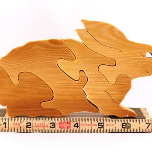 A wooden four piece puzzle in the shape of a rabbit. Perfect toddlers first puzzle.