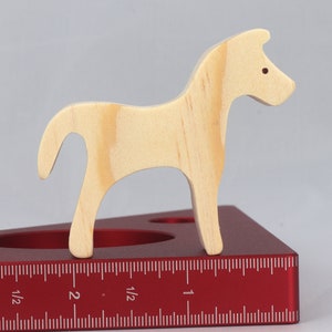 Handmade wooden toy horse cutout, perfect for children's playtime collection. Freestanding and stackable, ready to paint or customize. Endless possibilities for imaginative play, from farm scenes to towering animal creations.
