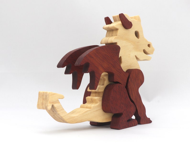 Hand-crafted baby dragon mythical fantasy animal figurine made from contrasting high-quality hardwoods and finished with non-toxic oils and waxes. Perfect for any dragon enthusiast.