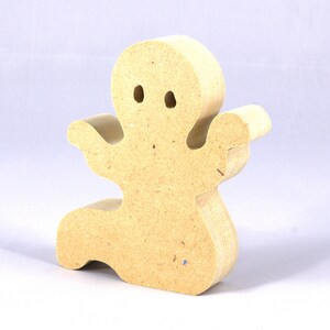 A handmade, unpainted wooden ghost cutout stands upright on a white background. The light-colored solid wood figure has a rounded head with two circular eye cutouts, raised wavy arms, and a curved wavy base, ready for painting or crafting.