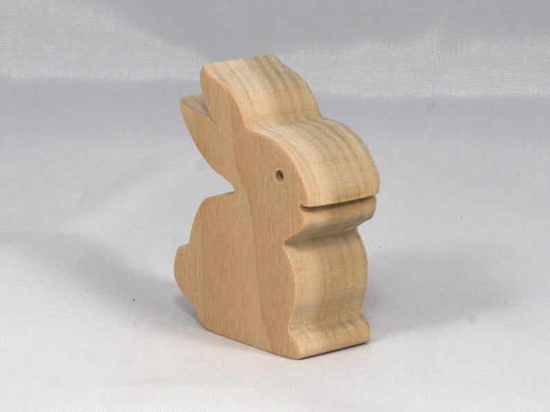This is an unfinished wooden Rabbit cutout from solid wood using traditional woodworking techniques. Sanded smooth and ready to paint, stain, or customize. Freestanding design for small hands, toddlers, young children, crafters, collectors, and display. I take custom orders for any animal, quantity, and mix — including large ornament orders. Mix and match, request a different size, or send a drawing or pattern. Handmade by Odin's Toy Factory in Tallahassee, Florida, USA.