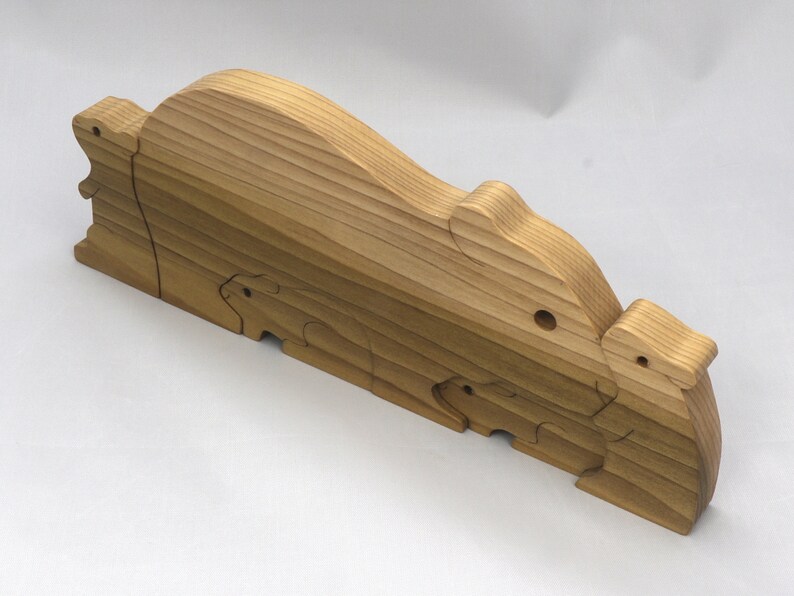 Handmade Wooden Stacking Puzzle Guinea Pig Family, Mom, and Babies finished with a non-toxic custom blend of mineral oil and waxes. This wooden toy animal is perfect for imaginative play and an excellent gift for children.