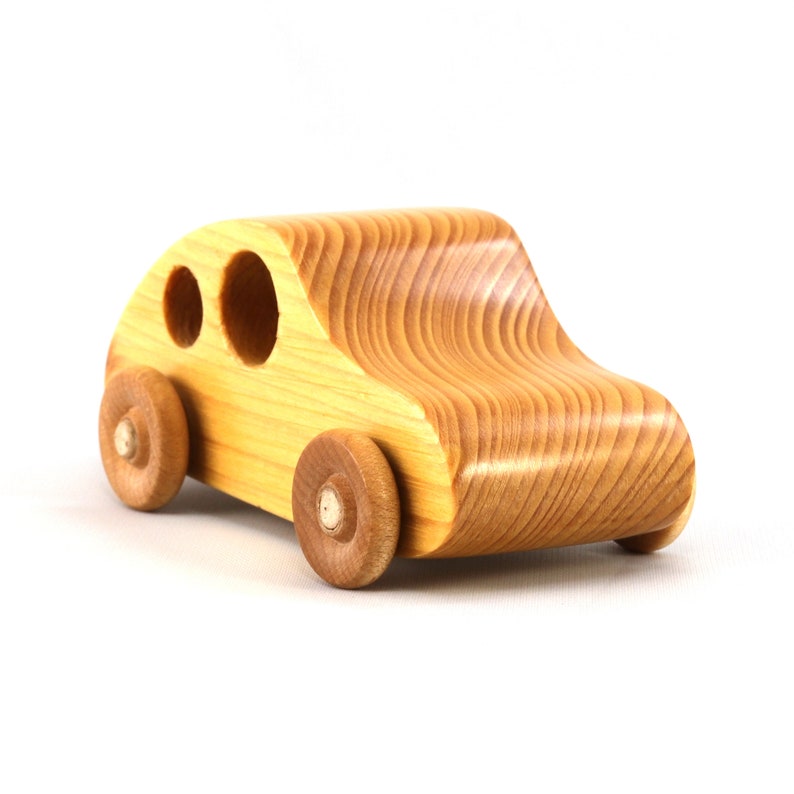 A handmade wooden toy car from the My Play Pal collection finished with durable satin polyurethane and amber shellac. It is made to order.