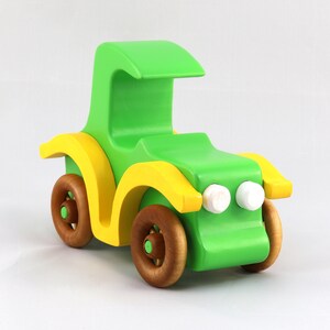 Handmade wooden toy car, vintage-style Model T sedan, painted bright green and yellow with spoked wheels, finished in amber shellac.  Handcrafted in Tallahassee, Florida, USA by Odin's Toy Factory.