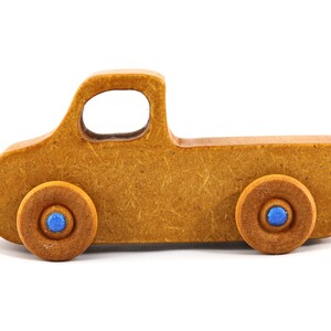 This handmade toy pickup truck from My Play Pal Collection is finished with amber shellac and metallic sapphire blue acrylic paint. It is just one of many unique wooden vehicles available.