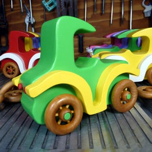 Handmade wooden toy car, vintage-style Model T sedan, painted bright green and yellow with spoked wheels, finished in amber shellac.  Handcrafted in Tallahassee, Florida, USA by Odin's Toy Factory.
